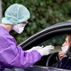 A doctor takes a sample for a coronavirus test on a fictional patient in her car at a drive-thru testing center on March 9, 2020 in Gross-Gerau, Germany in order to demonstrate for the media.